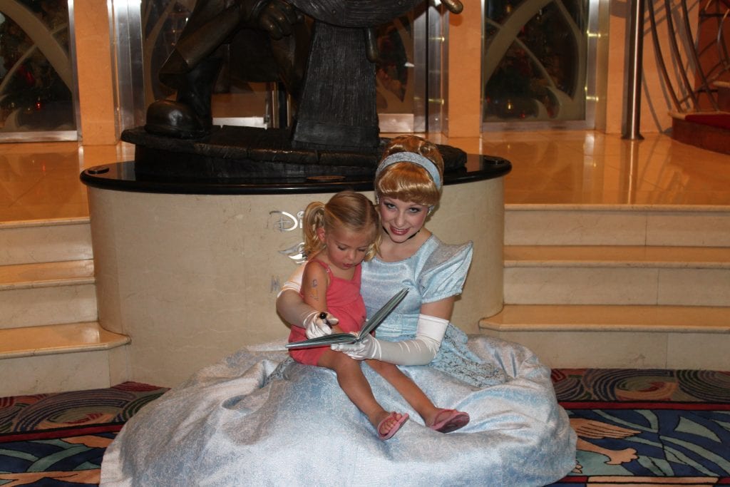 Little girl taking picture with Cinderella on board Disney Cruise Line | Global Munchkins