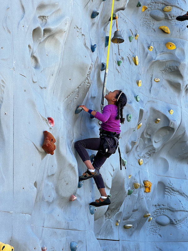 girl climbing rockwall
